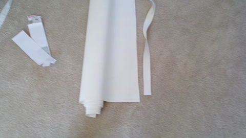 1900 Ford C-350 (Centurion Conversions) - Rolled white material and two white tags are shown on a carpeted surface.