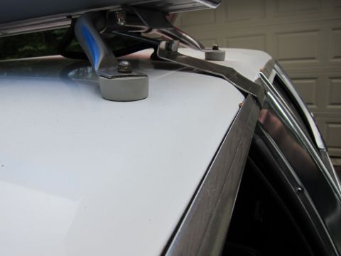1991 Ford LTD Crown Victoria - The mounting hardware for a roof rack is attached to the car's roof.