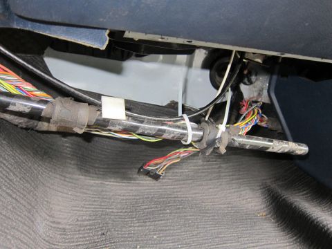 1991 Ford LTD Crown Victoria - A bundle of wires and cables are visible under the dashboard of a vehicle.