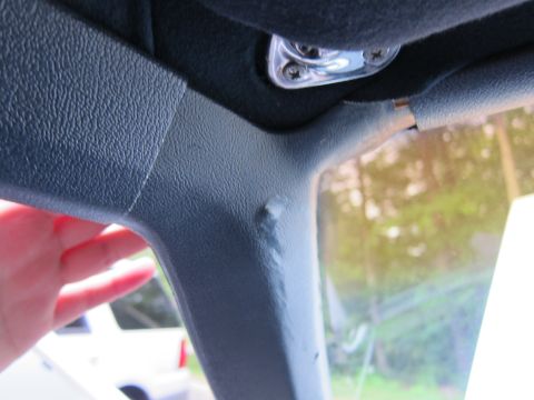 1991 Ford LTD Crown Victoria - View of the interior A-pillar trim and windshield, with a partial view of another vehicle outside.