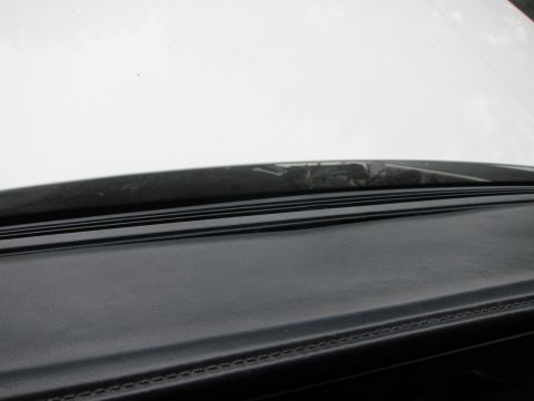 1991 Ford LTD Crown Victoria - Close-up view of a car's dashboard and the base of the windshield.