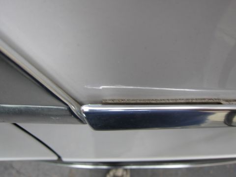 1991 Ford LTD Crown Victoria - Detail shot of chrome trim and body panel on a silver vehicle.