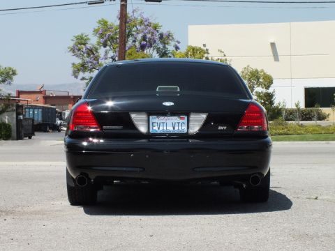 2003 Ford Crown Victoria - Straight-on tail shot of black Crown Victoria, dual exhaust and chrome trim