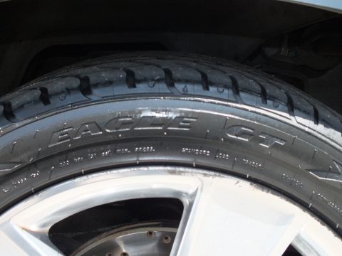 2003 Ford Crown Victoria - Detail of a Goodyear Eagle GT tire sidewall lettering mounted on a silver multi-spoke wheel
