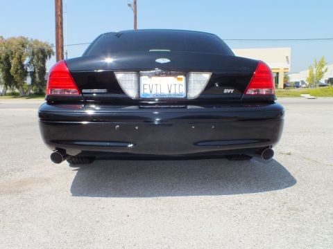 2003 Ford Crown Victoria - Tail view of a black Crown Victoria showing SVT badge, EVIL VTC plate and twin chrome exhaust outlets