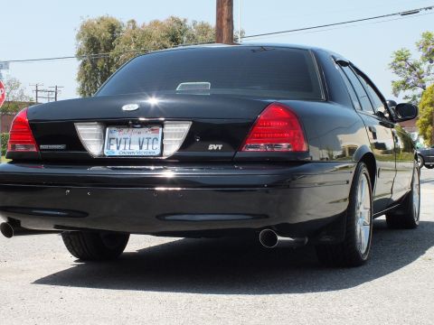 2003 Ford Crown Victoria - Tail view of a black Crown Victoria with SVT badge, EVIL VTC California plate and twin chrome exhaust tips