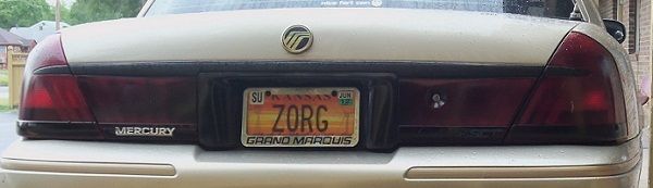 Rear of a 2000 Mercury Grand Marquis with a Kansas license plate that reads ZORG