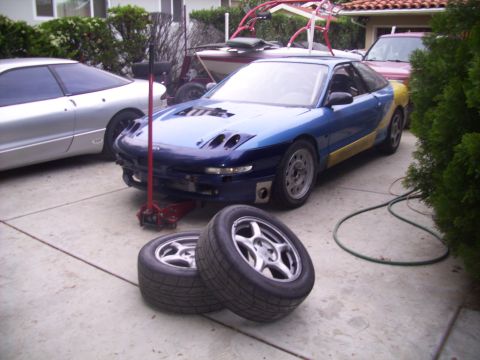 1995 Ford Probe - This 1995 Ford Probe is being worked on, with a second Probe visible in the driveway.