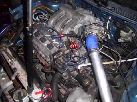 1995 Ford Probe - Close-up view of a modified engine bay, showing complex plumbing and engine components.