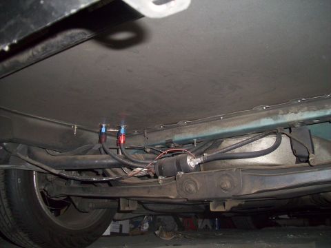 1995 Ford Probe - Underbody view of a fuel filter and lines, with visible fittings and hoses.
