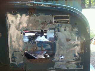 1978 Ford Bronco - This is a close-up of a vehicle's body panel undergoing repair, showing rust and a sticker with repair system information.