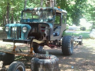 1978 Ford Bronco - This Jeep CJ-5 appears to be undergoing restoration or modification, with its front end disassembled and large tires fitted.