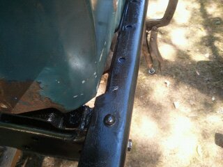 1978 Ford Bronco - Detail of vehicle frame and body panel, possibly undergoing restoration.