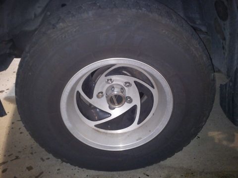 1997 Chevrolet Silverado 1500 - Close-up of a vehicle's wheel and tire, showing the alloy rim design.