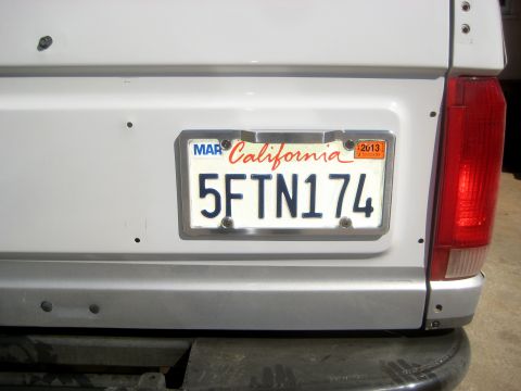 1996 Ford Bronco - California license plate 5FTN174 is mounted on the rear of a white vehicle.