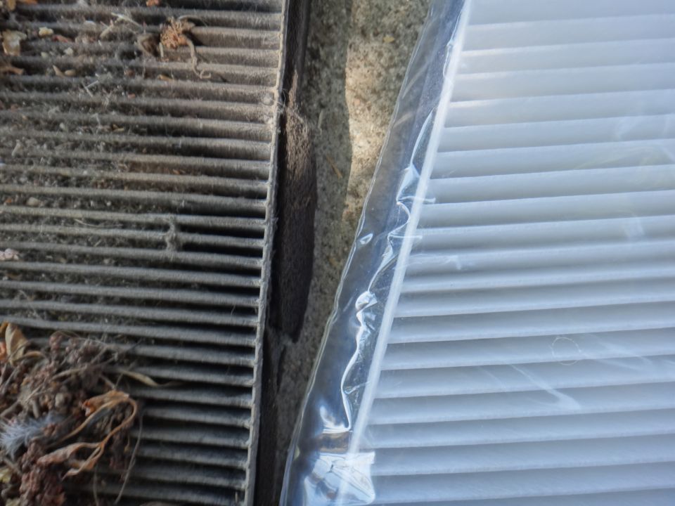 Dirty cabin air filter next to a new one
