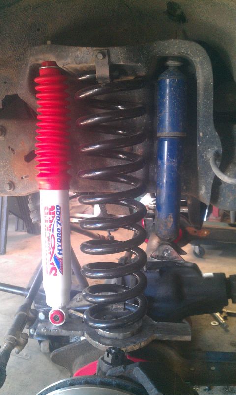 1987 Ford Bronco - Aftermarket suspension parts, including shocks and coil springs, are visible in this close-up.