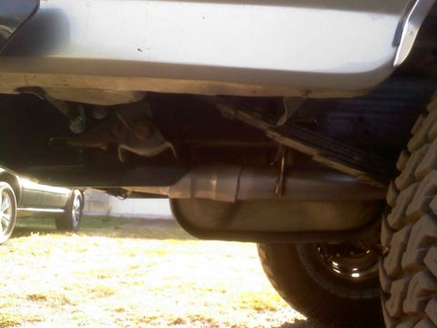 1996 Ford Bronco - Undercarriage detail of a vehicle, focusing on suspension and exhaust components.