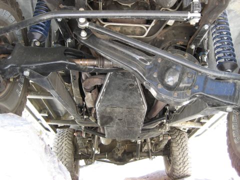 1996 Ford Bronco - The undercarriage of an off-road vehicle reveals its complex suspension and drivetrain systems.