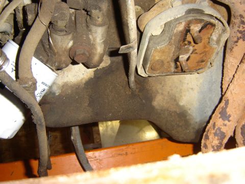 1982 Mercury Zephyr - This image shows a close-up view of an engine's oil filter and a motor mount, with visible signs of wear and oil residue.