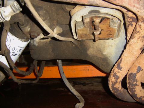 1982 Mercury Zephyr - Close-up view of engine components, including an oil filter and exhaust manifold, with an orange support visible underneath.