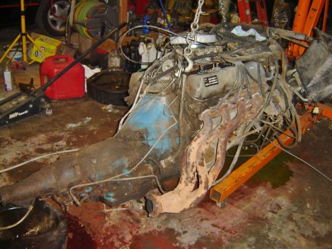 1982 Mercury Zephyr - Engine and transmission assembly, likely removed from a vehicle, sits on an engine stand.