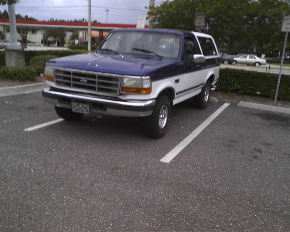 Blue and white 1996 Ford Bronco parked in a lot, 3q-front view