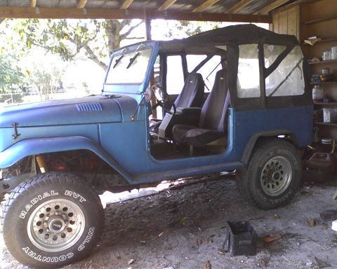 1969 Toyota Land Cruiser - A blue 1969 Toyota Land Cruiser sits in a garage with its doors open and a soft top installed.