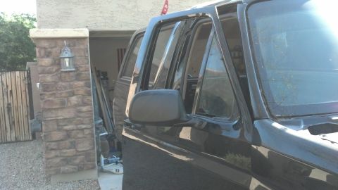 1995 Ford Bronco - Side view of a black SUV's door and window frame.