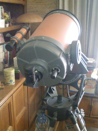1989 Ford Bronco - A large orange telescope is mounted on a tripod, with a smaller scope attached to its side.