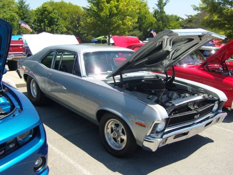 2007 Ford Mustang - Silver 1969 Chevrolet Nova SS at a car show, with a blue Camaro in the foreground.
