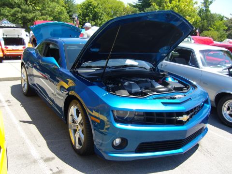 2007 Ford Mustang - A blue Chevrolet Camaro is displayed with its hood open, the engine bay.