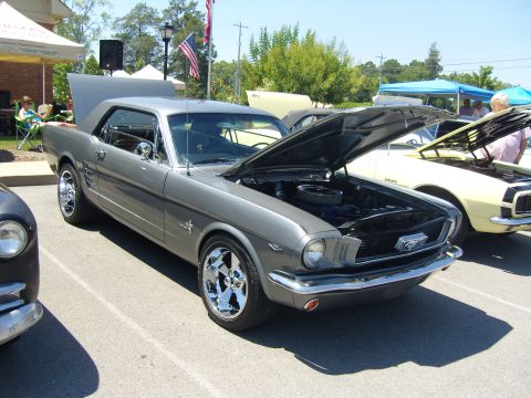 2007 Ford Mustang - A classic gray Ford Mustang is displayed with its hood open at an outdoor event.