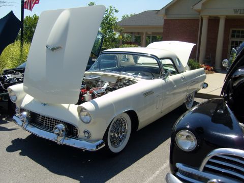 2007 Ford Mustang - A white 1955 Ford Thunderbird is displayed with its hood and trunk open, parked alongside another vehicle.