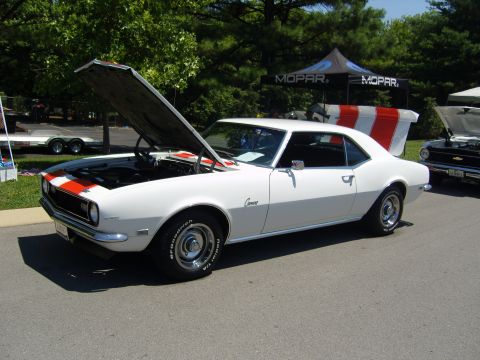 2007 Ford Mustang - A white 1967 Chevrolet Camaro with racing stripes is displayed with its hood and trunk open.