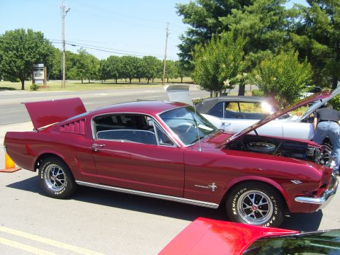2007 Ford Mustang - A classic red Mustang is displayed with its hood and trunk open, parked next to another vehicle.