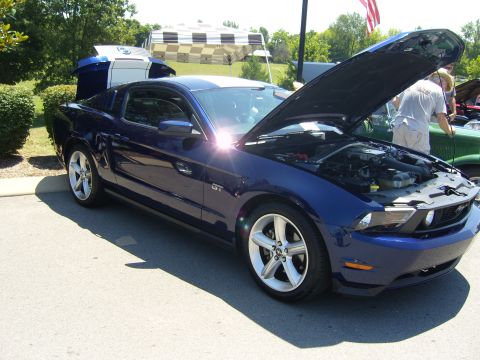 2007 Ford Mustang - Blue 2007 Ford Mustang GT at an outdoor car show, hood and trunk open.