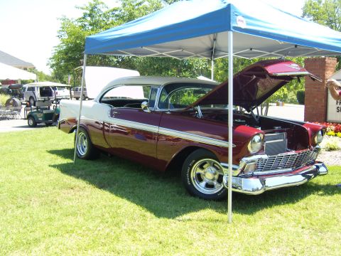 2007 Ford Mustang - A two-tone 1956 Chevrolet Bel Air is displayed at an outdoor event with its hood up.