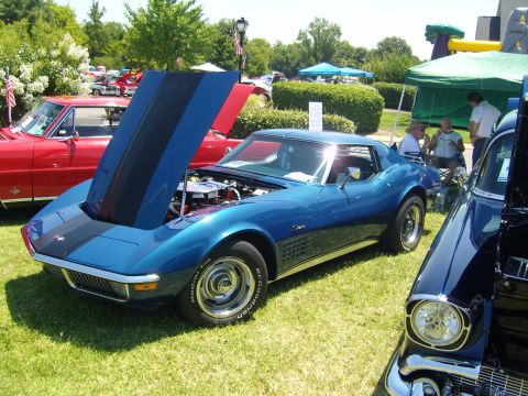 2007 Ford Mustang - A blue 1970 Chevrolet Corvette is displayed with its hood open at an outdoor car show.