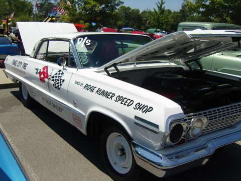 2007 Ford Mustang - A white coupe with its hood open, displaying "TUNED BY: RIDGE RUNNER SPEED SHOP" and a checkered flag graphic.
