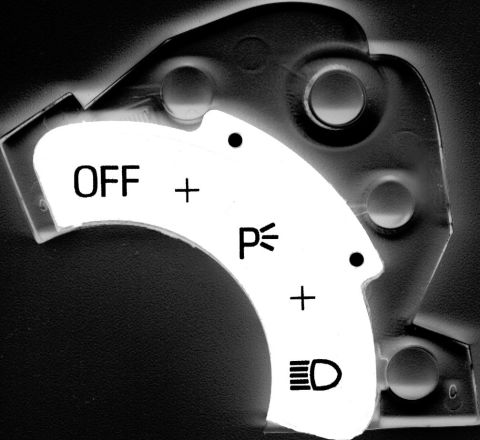1995 Ford Taurus - Close-up of a vehicle's headlight switch, showing the OFF, Parking light, and Headlight settings.