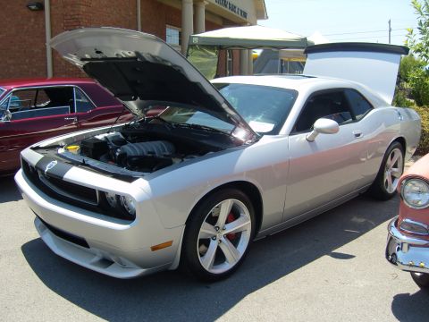 2007 Ford Mustang - A silver Dodge Challenger is displayed with its hood and trunk open at an outdoor event.