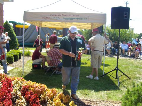 2007 Ford Mustang - An outdoor event is underway with a tent providing shade and trophies on display.