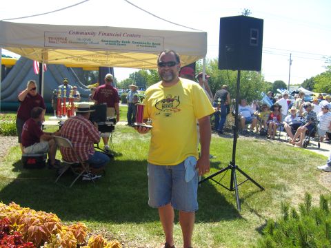 2007 Ford Mustang - Outdoor event with a man holding a trophy, tents, and spectators in the background.