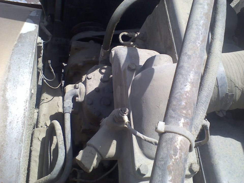 Engine components and hoses on a dusty truck