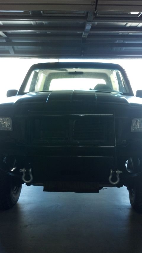 1995 Ford Bronco - Front view of a black 1995 Ford Bronco, its grille and tow hooks.