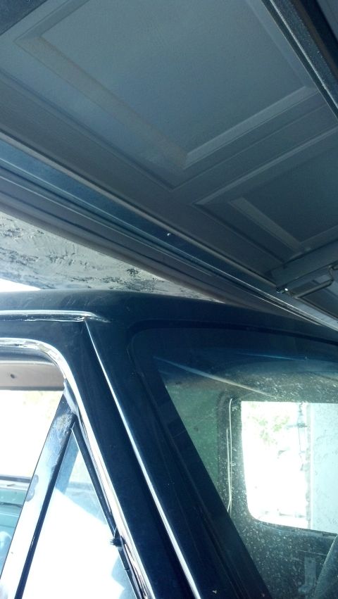 1995 Ford Bronco - The interior ceiling panel of a vehicle shows a textured, segmented design.