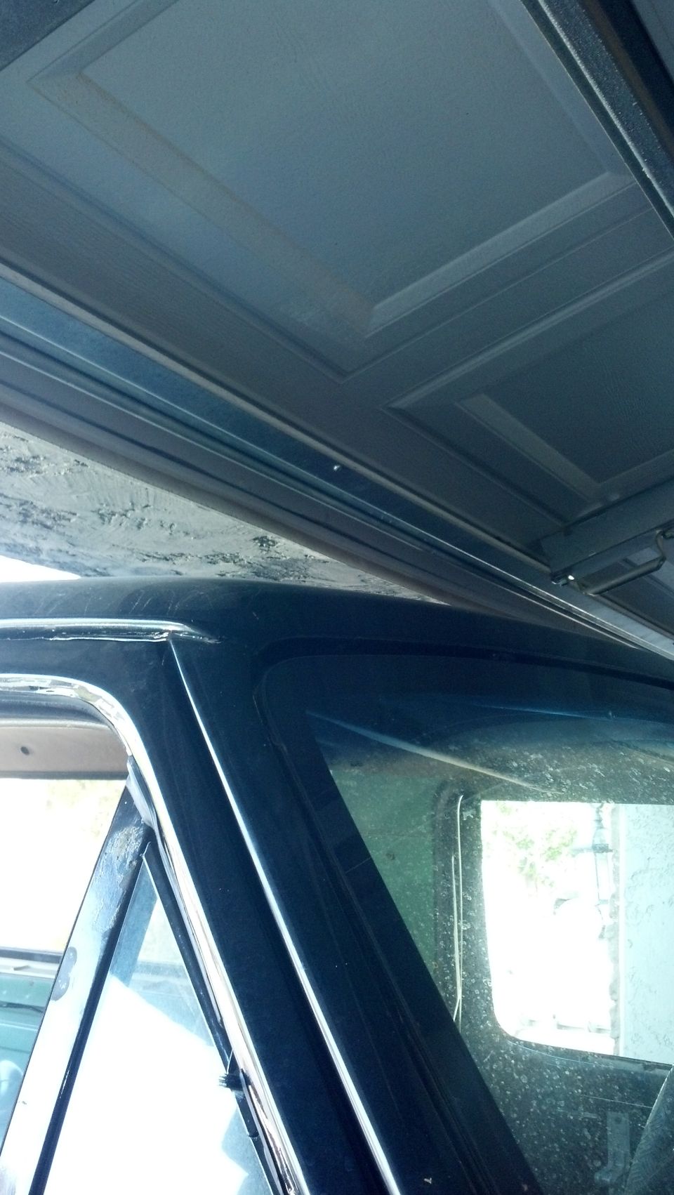 view of the inside roof panel and window frame of a vehicle