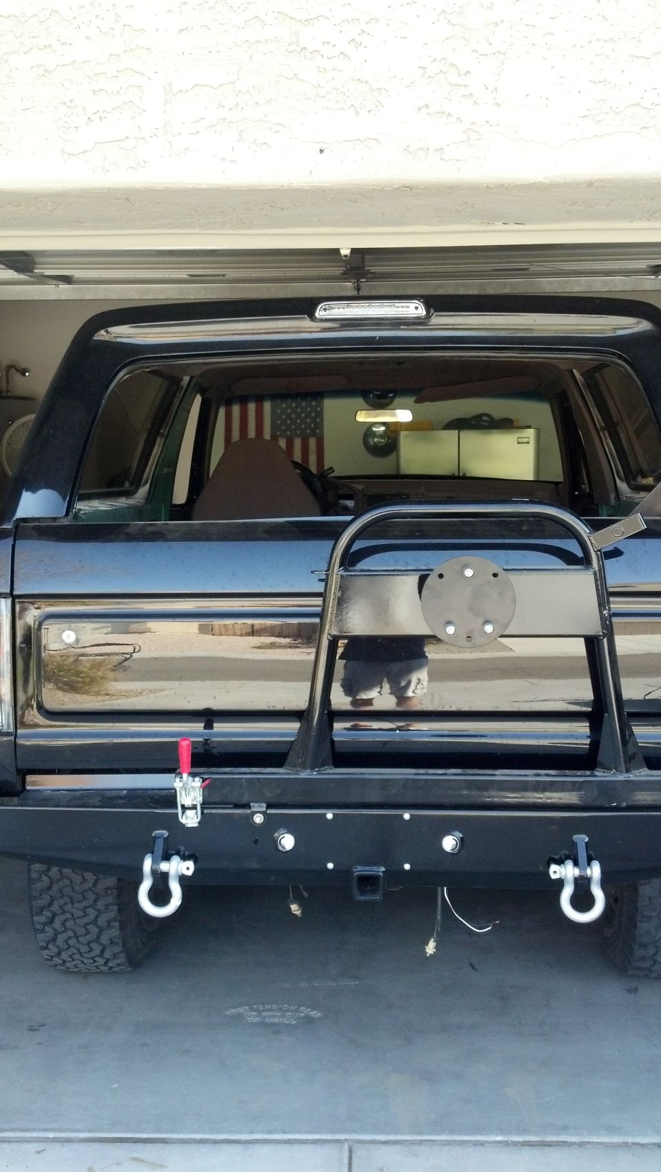Black 1995 Ford Bronco rear view with spare tire carrier and tow hitch