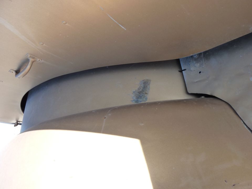 Close-up of a truck's tan fender and inner wheel well area